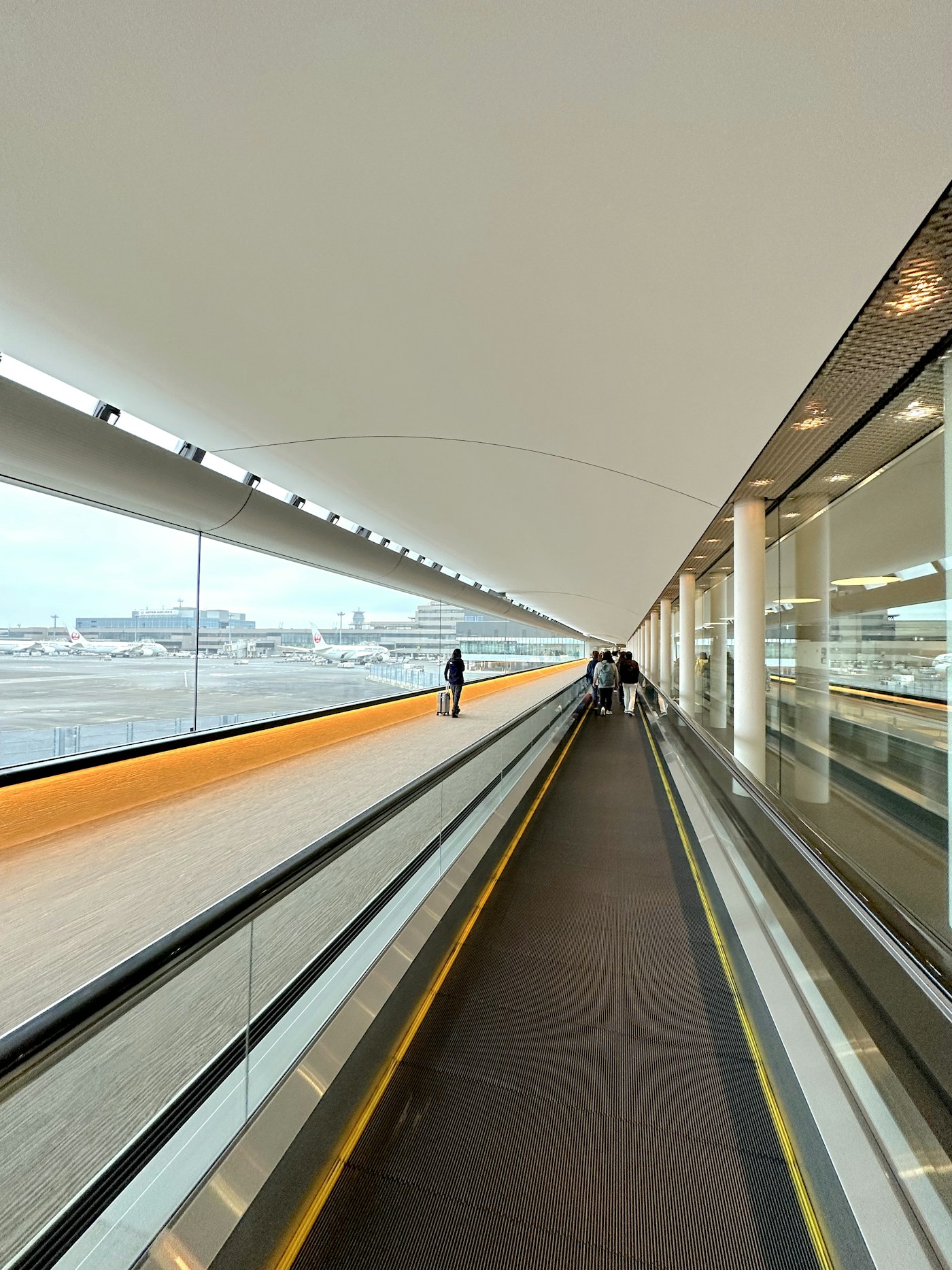 Passenger moving through a long airport walkway